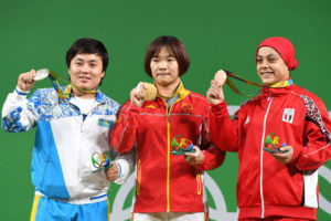 China's Xiang Yanmei (C) poses on the podium with silver medallist Kazakhstan's Zhazira Zhapparkul (L) and bronze medallist Egypt's Sara Ahmed after she won the Women's 69kg weightlifting competition at the Rio 2016 Olympic Games in Rio de Janeiro on August 10, 2016.  / AFP / GOH Chai Hin        (Photo credit should read GOH CHAI HIN/AFP/Getty Images)